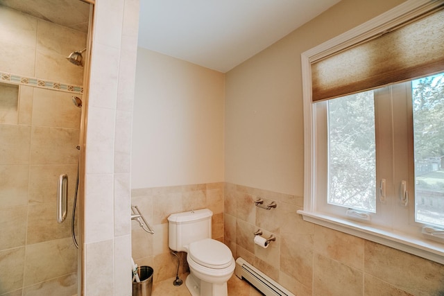 bathroom featuring toilet, a baseboard radiator, tile walls, and a shower stall
