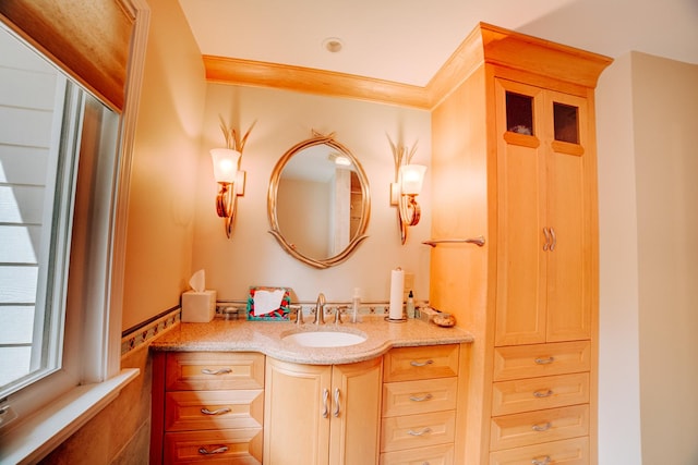 bathroom featuring crown molding and vanity
