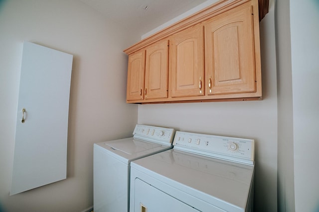 laundry area with cabinet space and independent washer and dryer