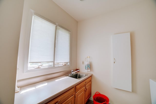 kitchen featuring a sink, brown cabinetry, and light countertops
