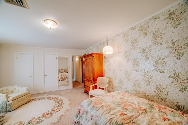 bedroom with carpet flooring, crown molding, and visible vents