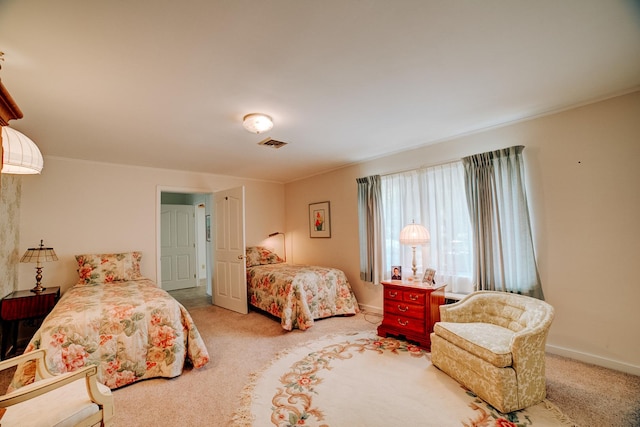 bedroom with baseboards, crown molding, visible vents, and carpet
