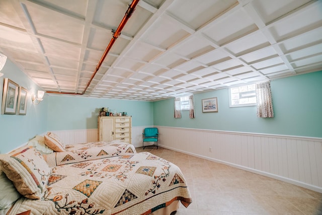 bedroom featuring tile patterned flooring and wainscoting