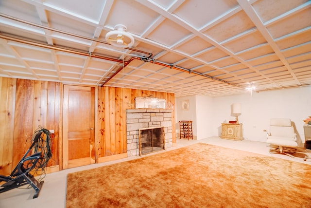 finished below grade area with wooden walls and a fireplace