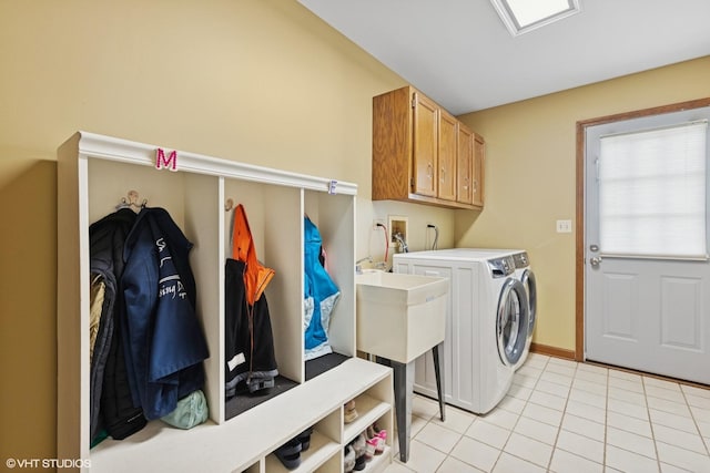 500 Easy St, Darien, IL 60561 - clothes washing area featuring a sink, cabinet space, separate washer and dryer, light tile patterned floors, and baseboards