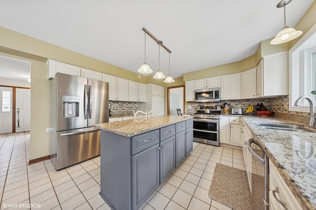 500 Easy St, Darien, IL 60561 - kitchen with a sink, stainless steel appliances, gray cabinets, light tile patterned floors, and a kitchen island