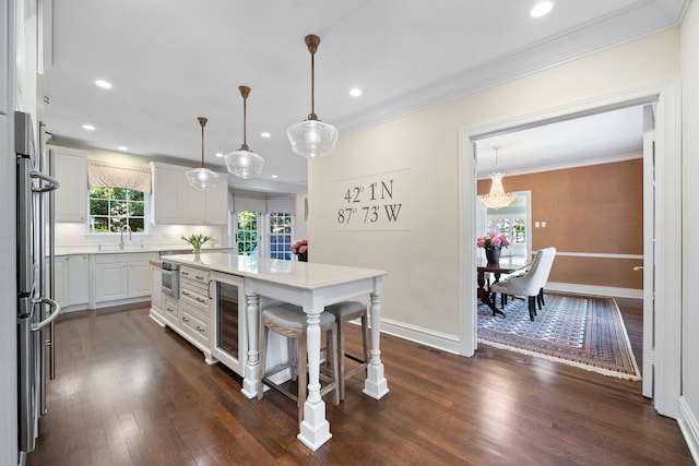 kitchen with wine cooler, white cabinetry, light countertops, dark wood-type flooring, and crown molding
