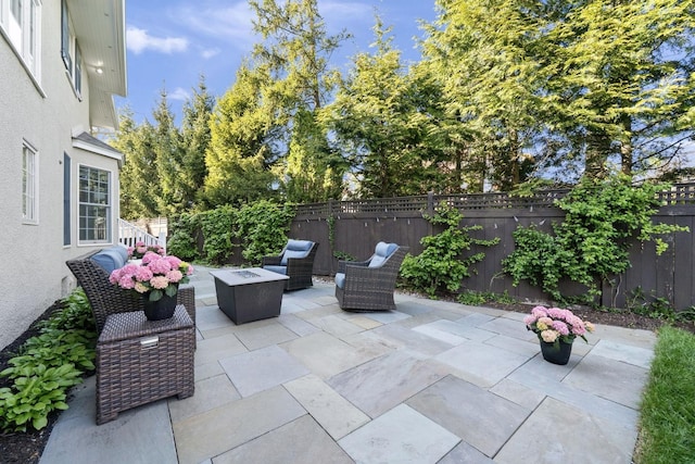 view of patio featuring a fenced backyard and an outdoor fire pit