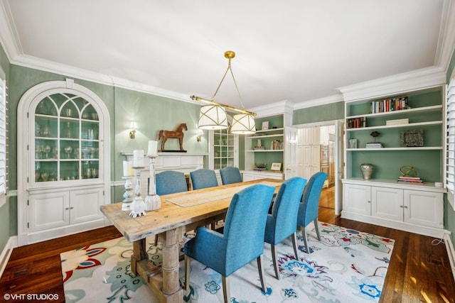 dining space featuring ornamental molding and dark wood finished floors