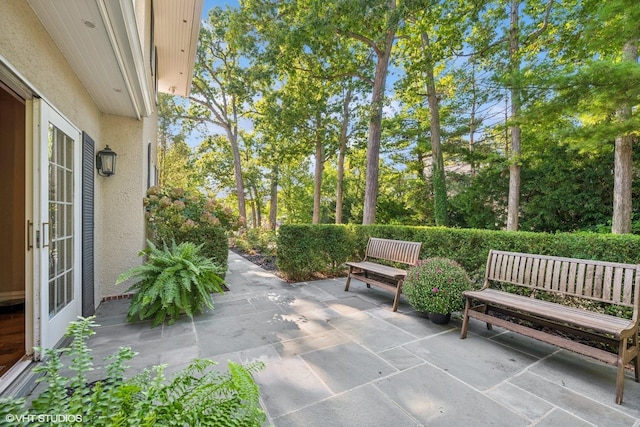view of patio / terrace featuring view of wooded area