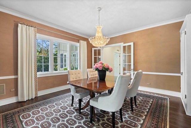 dining space featuring baseboards, a chandelier, dark wood-style flooring, and ornamental molding