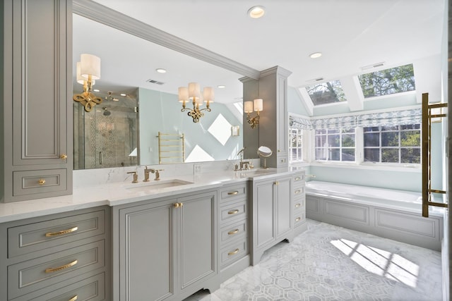 bathroom with a skylight, a shower stall, vanity, a garden tub, and recessed lighting
