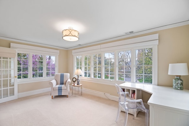 living area featuring baseboards, light colored carpet, plenty of natural light, and crown molding