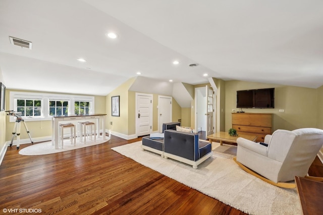 living room with wood finished floors, lofted ceiling, baseboards, and recessed lighting