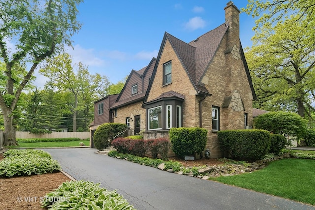 625 Greenbriar Ln, Lake Forest, IL 60045 - view of front of house with a chimney, brick siding, and roof with shingles