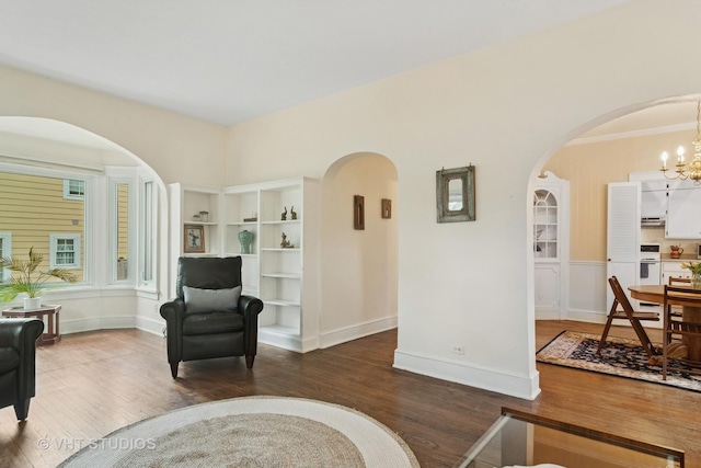 625 Greenbriar Ln, Lake Forest, IL 60045 - sitting room with wood finished floors, arched walkways, a chandelier, and baseboards