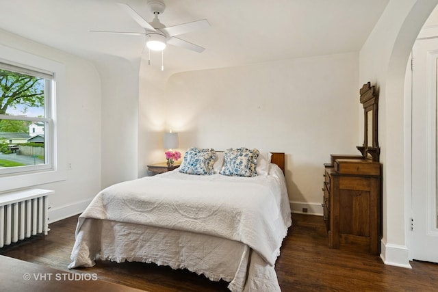 625 Greenbriar Ln, Lake Forest, IL 60045 - bedroom with radiator heating unit, wood finished floors, arched walkways, and baseboards
