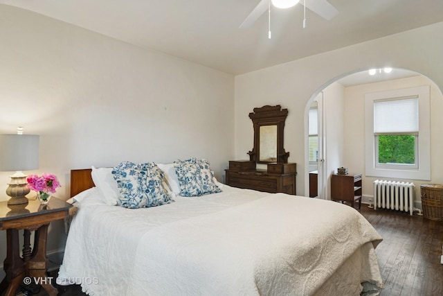 625 Greenbriar Ln, Lake Forest, IL 60045 - bedroom featuring radiator, arched walkways, wood-type flooring, a ceiling fan, and baseboards