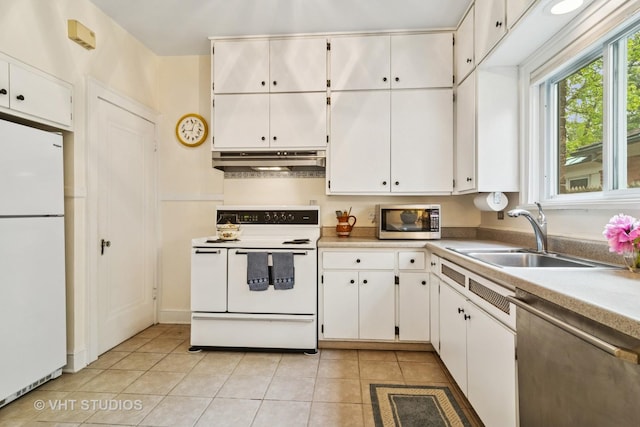 625 Greenbriar Ln, Lake Forest, IL 60045 - kitchen with stainless steel appliances, a sink, under cabinet range hood, and light tile patterned floors