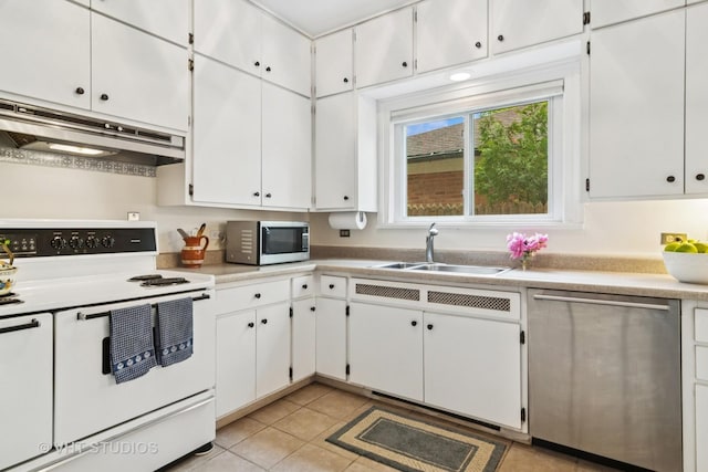 625 Greenbriar Ln, Lake Forest, IL 60045 - kitchen featuring appliances with stainless steel finishes, under cabinet range hood, a sink, light tile patterned flooring, and light countertops