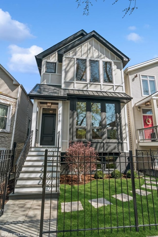 1928 W George St, Chicago, IL 60657 - view of front facade with a standing seam roof, a fenced front yard, and a metal roof