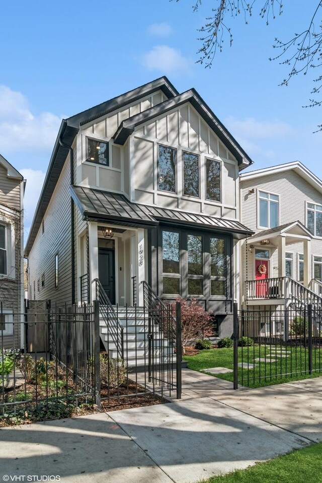 1928 W George St, Chicago, IL 60657 - view of front of house with a standing seam roof, a fenced front yard, and a metal roof