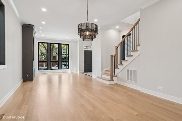 1928 W George St, Chicago, IL 60657 - unfurnished living room with ornamental molding, recessed lighting, light wood-style flooring, a chandelier, and stairs