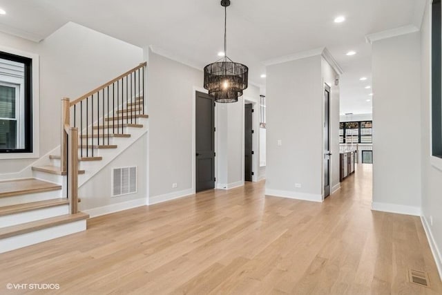 1928 W George St, Chicago, IL 60657 - unfurnished living room with crown molding, light wood-style floors, a chandelier, stairway, and recessed lighting