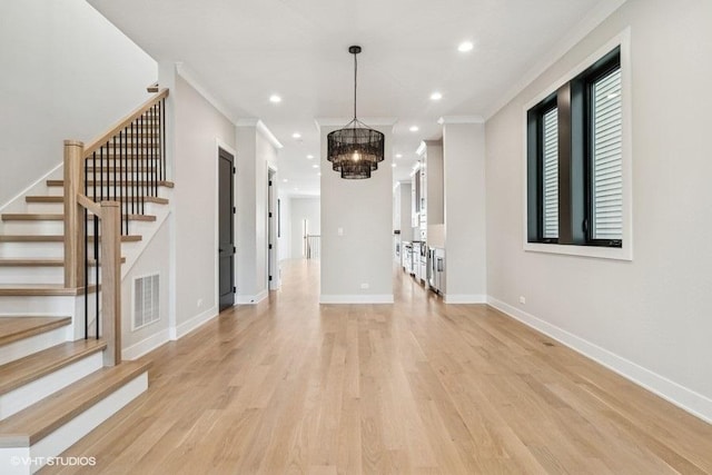 1928 W George St, Chicago, IL 60657 - unfurnished living room with light wood-style flooring, a chandelier, recessed lighting, stairway, and ornamental molding