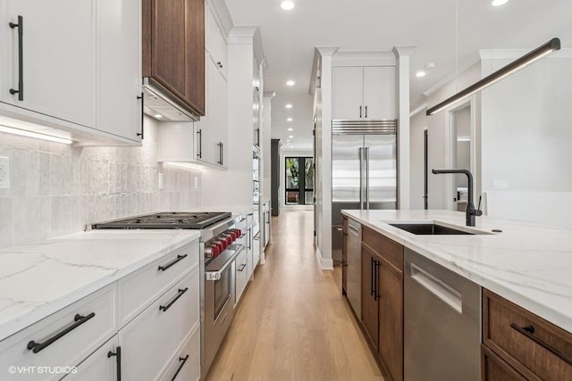 1928 W George St, Chicago, IL 60657 - kitchen with high end appliances, light wood finished floors, recessed lighting, white cabinets, and decorative backsplash