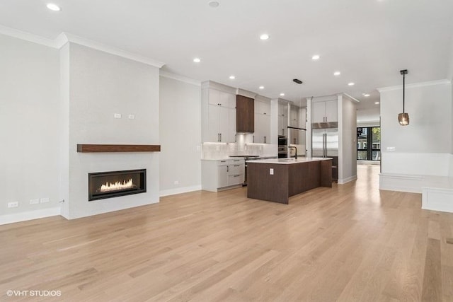 1928 W George St, Chicago, IL 60657 - kitchen featuring crown molding, a kitchen island with sink, light countertops, stainless steel built in refrigerator, and a fireplace