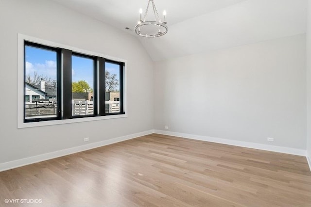 1928 W George St, Chicago, IL 60657 - unfurnished room featuring a chandelier, vaulted ceiling, and light wood finished floors