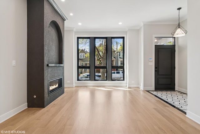 1928 W George St, Chicago, IL 60657 - entrance foyer with wood finished floors, crown molding, a fireplace, and recessed lighting