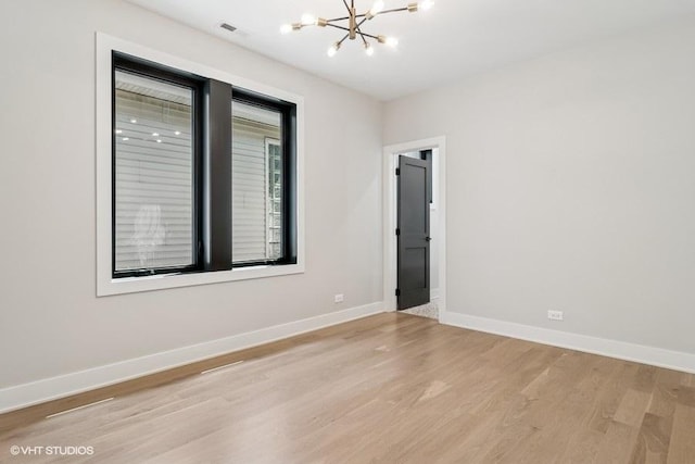 1928 W George St, Chicago, IL 60657 - spare room featuring a chandelier and light wood finished floors