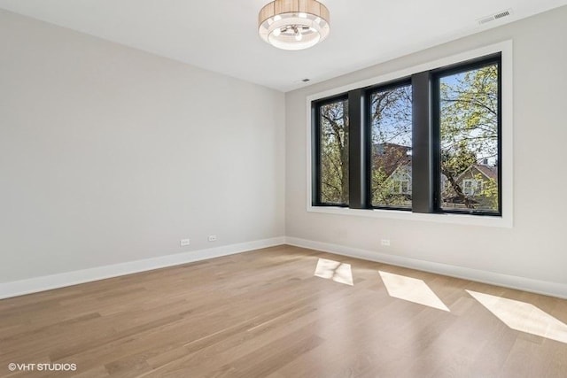 1928 W George St, Chicago, IL 60657 - empty room with plenty of natural light and light wood finished floors