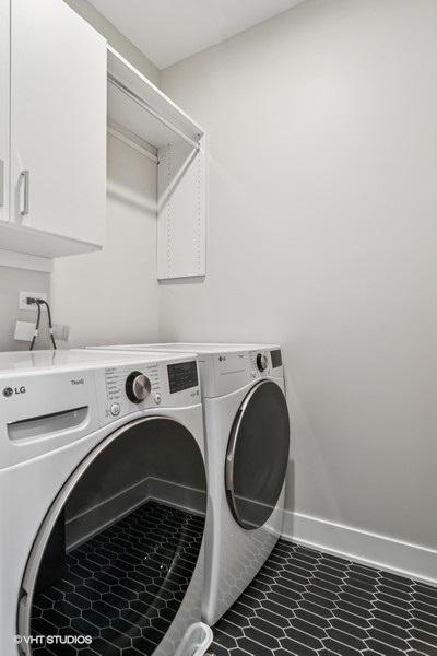 1928 W George St, Chicago, IL 60657 - laundry area with independent washer and dryer, cabinet space, and tile patterned floors
