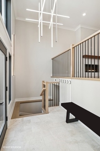 1928 W George St, Chicago, IL 60657 - stairs with crown molding, a towering ceiling, and recessed lighting
