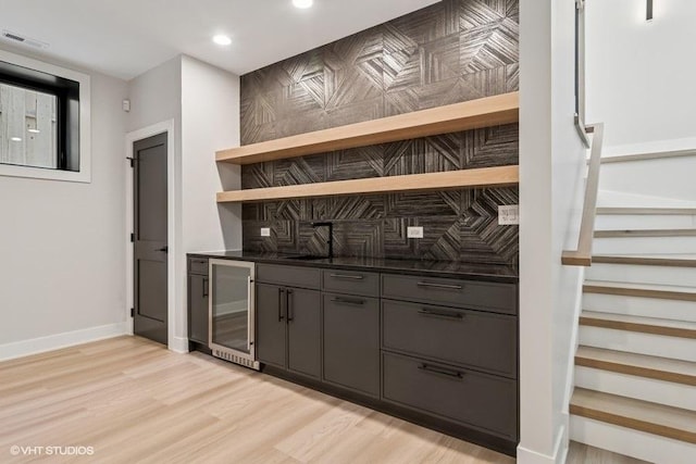 1928 W George St, Chicago, IL 60657 - indoor bar with beverage cooler, tasteful backsplash, light wood-style floors, recessed lighting, and stairs