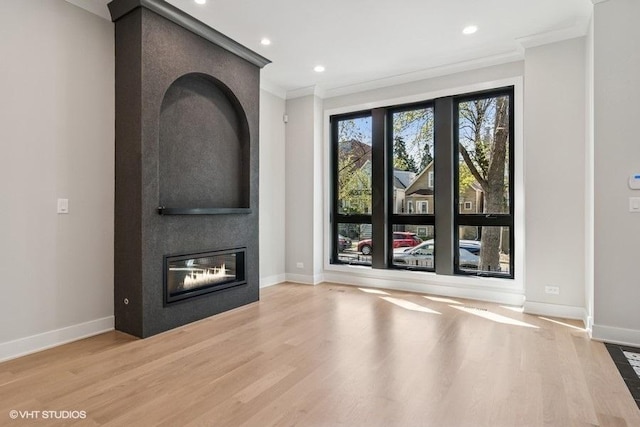 1928 W George St, Chicago, IL 60657 - unfurnished living room featuring ornamental molding, a large fireplace, wood finished floors, and recessed lighting