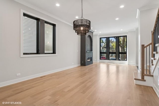 1928 W George St, Chicago, IL 60657 - unfurnished living room featuring stairs, crown molding, recessed lighting, a chandelier, and light wood-style floors
