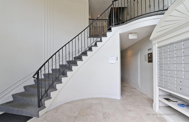 5201 Carriageway Dr Unit 311, Rolling Meadows, IL 60008 - stairway with baseboards and a towering ceiling