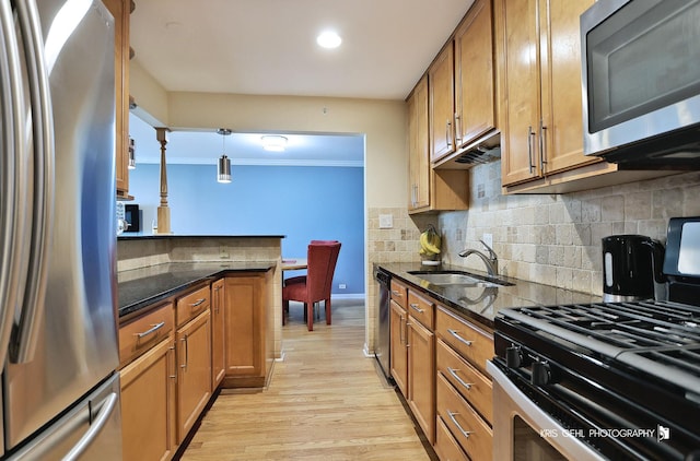 5201 Carriageway Dr Unit 311, Rolling Meadows, IL 60008 - kitchen featuring decorative backsplash, brown cabinets, a sink, stainless steel appliances, and light wood-style flooring