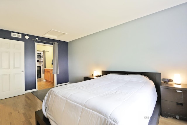5201 Carriageway Dr Unit 311, Rolling Meadows, IL 60008 - bedroom featuring baseboards, visible vents, light wood finished floors, and attic access