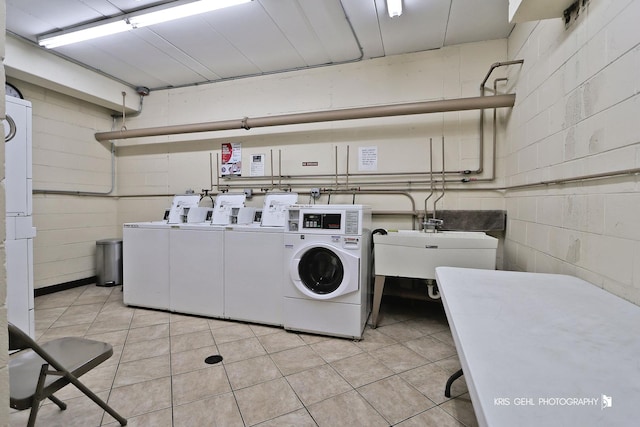 5201 Carriageway Dr Unit 311, Rolling Meadows, IL 60008 - shared laundry area featuring light tile patterned floors, washing machine and dryer, and concrete block wall