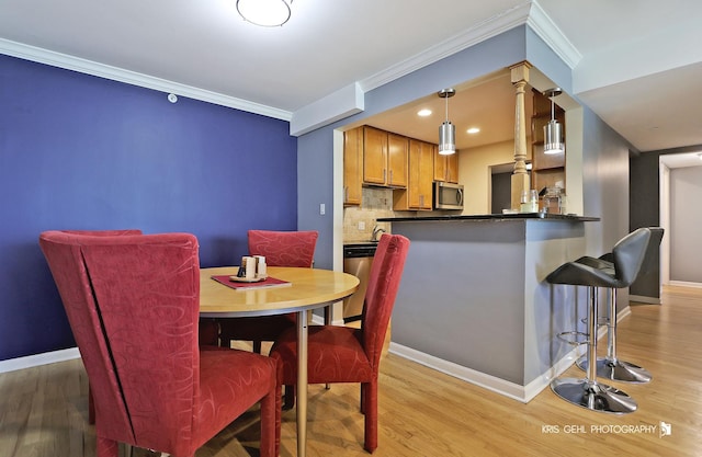 5201 Carriageway Dr Unit 311, Rolling Meadows, IL 60008 - dining area with baseboards, ornamental molding, and light wood-style flooring