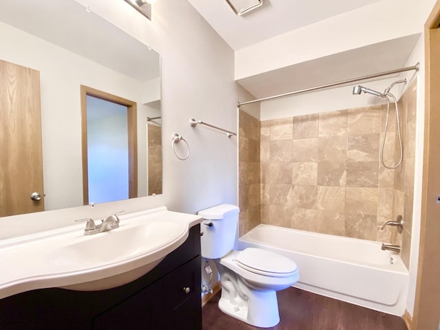 bathroom with toilet,  shower combination, wood finished floors, and vanity