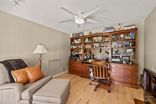 office area featuring a ceiling fan, light wood-type flooring, and baseboards