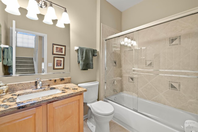 full bath featuring toilet, vanity, enclosed tub / shower combo, and tile patterned flooring