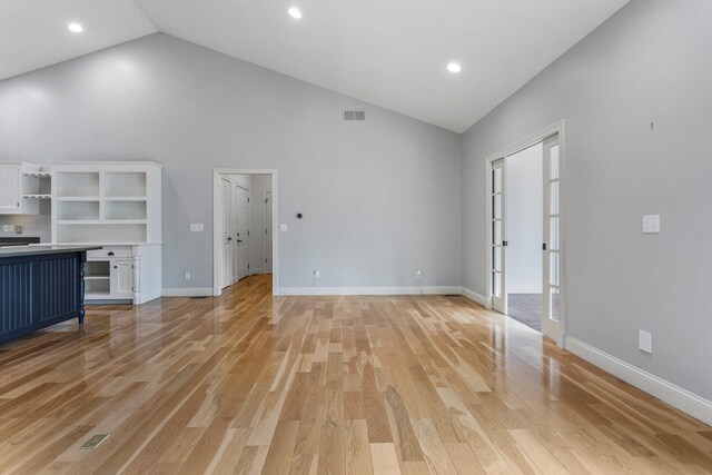 unfurnished living room featuring high vaulted ceiling, light wood-style floors, baseboards, and recessed lighting