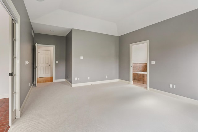 empty room with baseboards, light carpet, and lofted ceiling